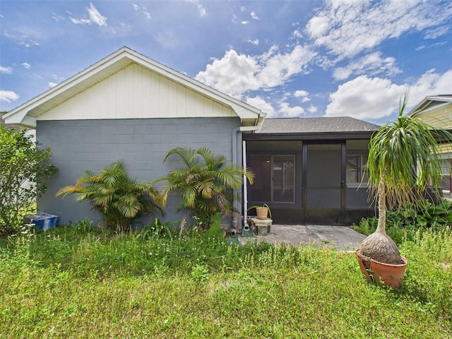 back of property featuring a sunroom