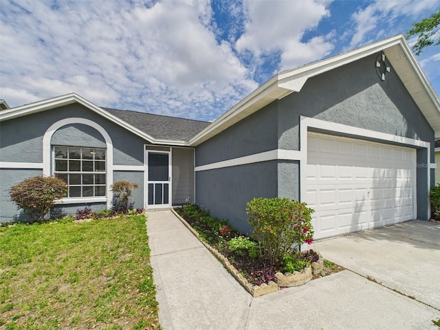single story home featuring driveway, stucco siding, and a garage