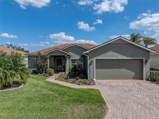 single story home featuring a garage, decorative driveway, stucco siding, and a front lawn