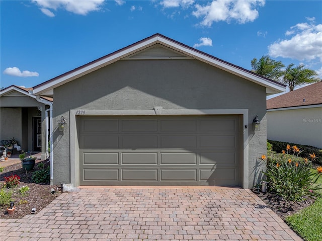 garage featuring decorative driveway