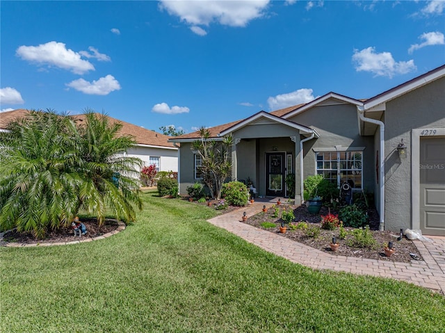 exterior space featuring a front yard, stucco siding, and an attached garage