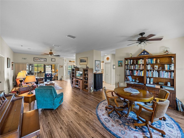 living area featuring visible vents, wood finished floors, and a ceiling fan