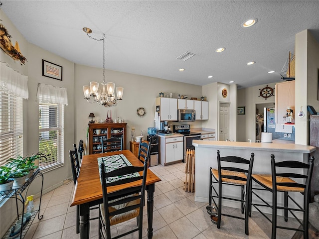 dining room featuring recessed lighting, light tile patterned floors, a textured ceiling, visible vents, and a notable chandelier