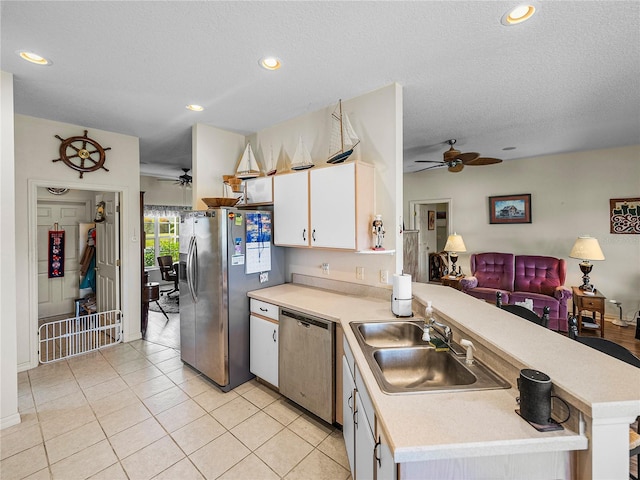 kitchen with light countertops, stainless steel appliances, and a ceiling fan