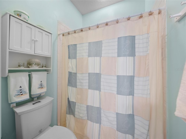 bathroom with toilet and curtained shower