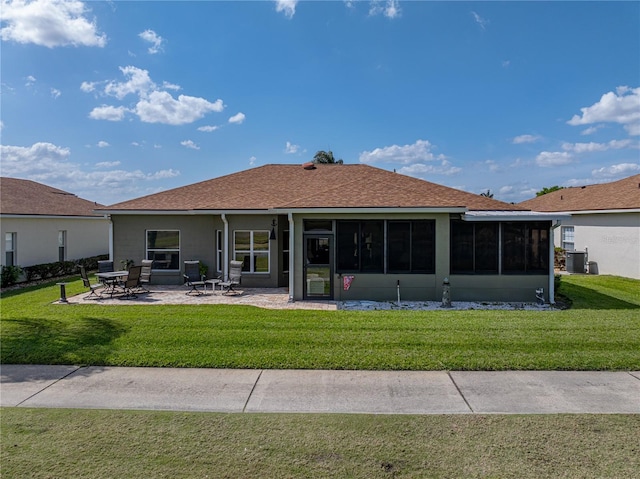 back of property with cooling unit, a lawn, a sunroom, and a patio