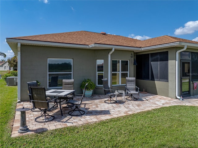 back of house with a patio, a lawn, and stucco siding