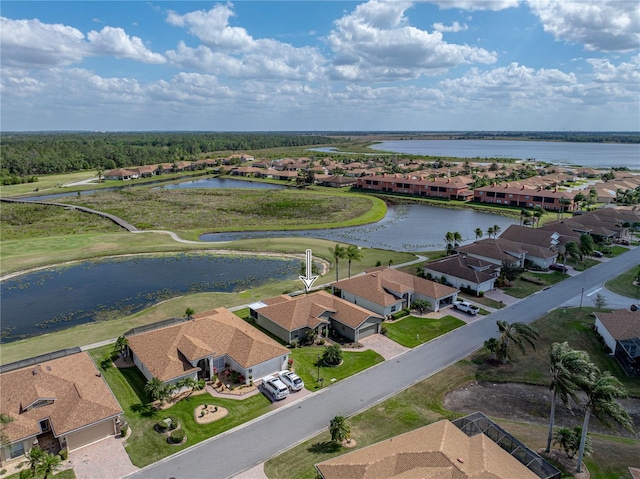 drone / aerial view with a water view and a residential view