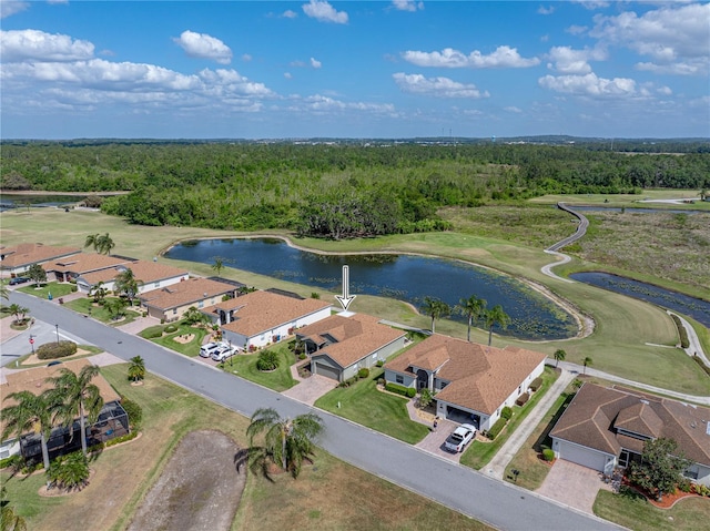aerial view featuring a residential view, a water view, and a wooded view