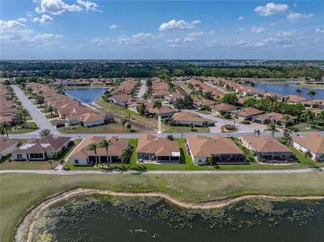 drone / aerial view with a residential view and a water view