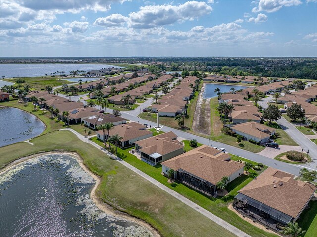 birds eye view of property featuring a water view and a residential view