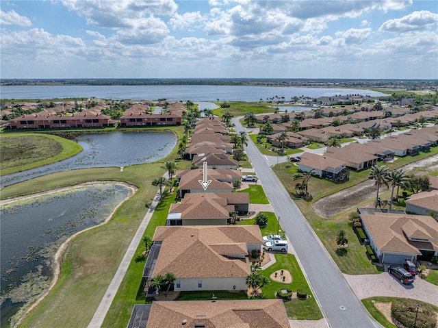 bird's eye view featuring a water view and a residential view