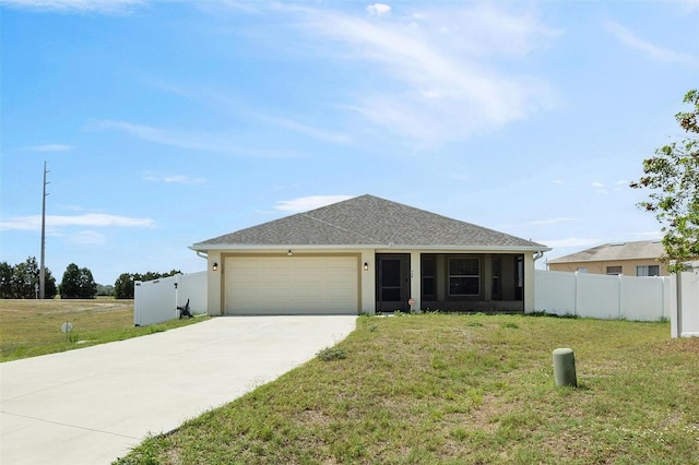 ranch-style house featuring fence, an attached garage, driveway, a front lawn, and a shingled roof
