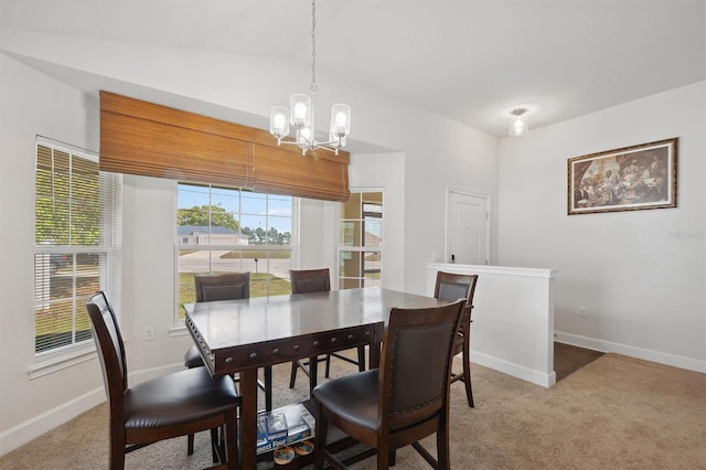 dining room featuring baseboards, an inviting chandelier, and light colored carpet