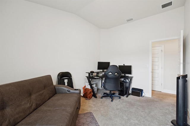 carpeted office space with lofted ceiling and visible vents