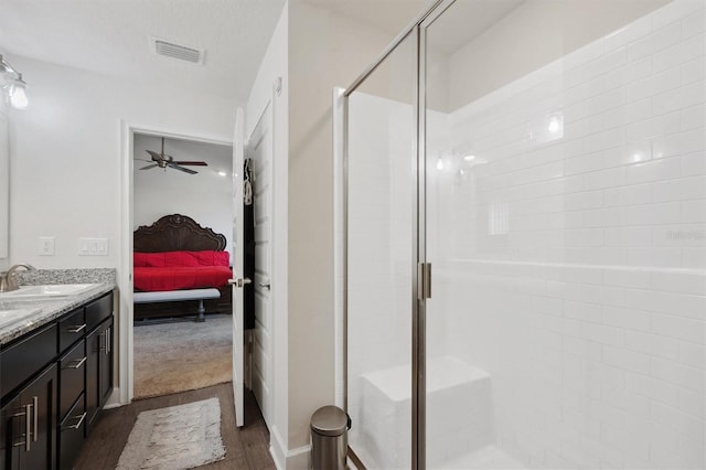 ensuite bathroom featuring ensuite bathroom, visible vents, a shower stall, vanity, and a ceiling fan