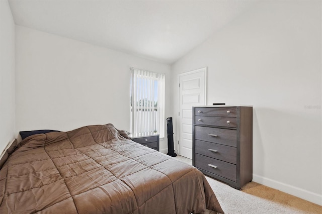 bedroom featuring vaulted ceiling, baseboards, and light colored carpet