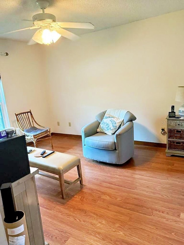 2761 Graniteridge Ct, Orange Park, FL 32065 - sitting room featuring light wood-type flooring, a ceiling fan, a textured ceiling, and baseboards
