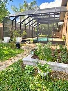 2761 Graniteridge Ct, Orange Park, FL 32065 - view of yard featuring an outdoor pool and glass enclosure