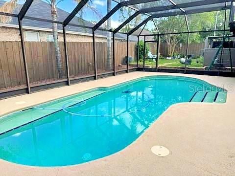 2761 Graniteridge Ct, Orange Park, FL 32065 - view of swimming pool with a fenced backyard, a patio area, and a lanai