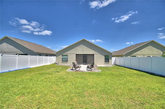 back of property with a patio, a fenced backyard, stucco siding, and a lawn