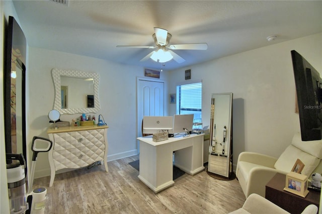 office featuring light wood finished floors, baseboards, and a ceiling fan