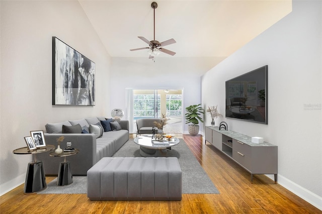 living room with lofted ceiling, baseboards, wood finished floors, and ceiling fan