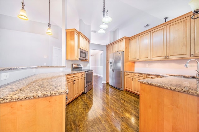 kitchen with light stone countertops, a peninsula, a sink, stainless steel appliances, and light brown cabinets