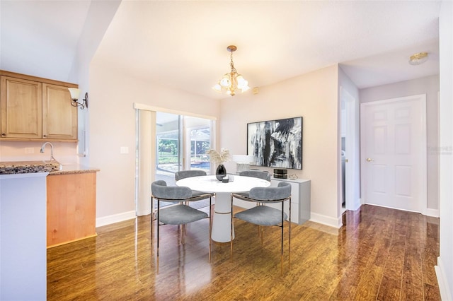 dining area featuring baseboards, an inviting chandelier, and wood finished floors