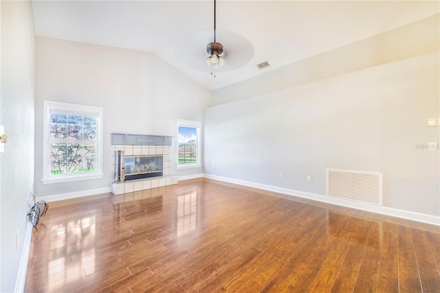 unfurnished living room with wood finished floors, ceiling fan, vaulted ceiling, and visible vents
