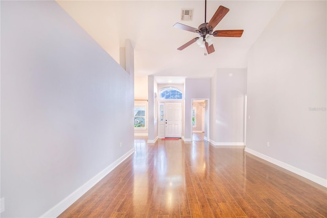 spare room with wood finished floors, baseboards, a ceiling fan, and visible vents
