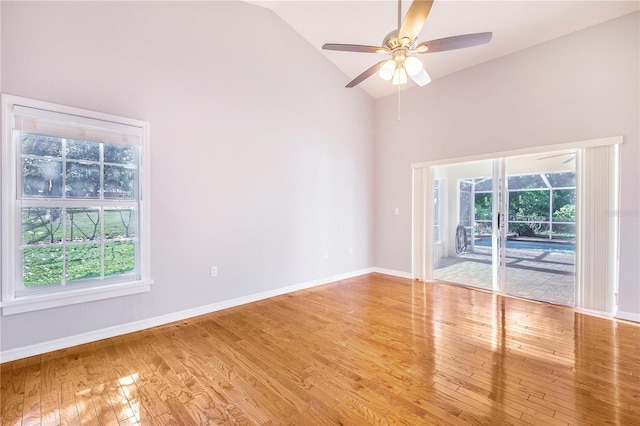 unfurnished room with light wood-style flooring, a healthy amount of sunlight, ceiling fan, and baseboards
