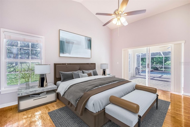 bedroom with light wood-style flooring, access to exterior, baseboards, and lofted ceiling