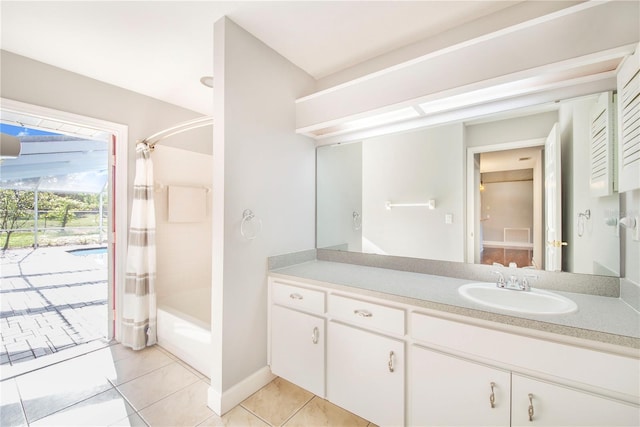 bathroom with shower / tub combo, baseboards, tile patterned flooring, and vanity