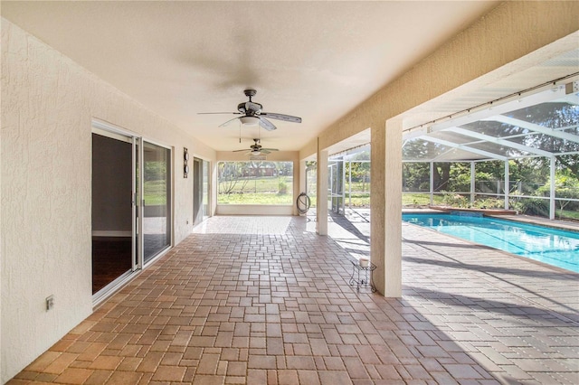 view of patio featuring an outdoor pool, a lanai, and ceiling fan