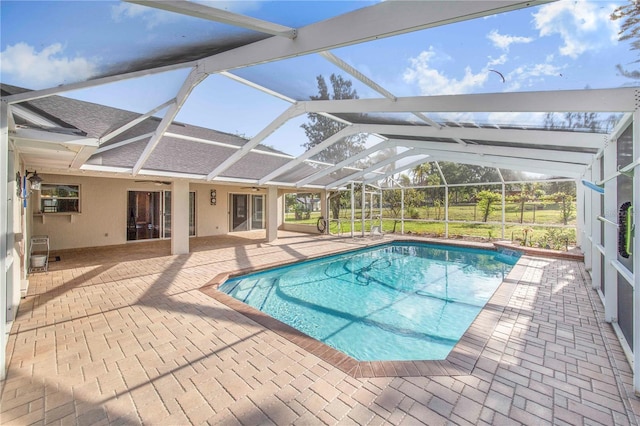 outdoor pool featuring a ceiling fan, a patio, and a lanai