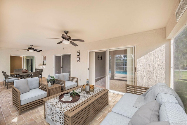 view of patio with outdoor dining area, visible vents, a ceiling fan, and an outdoor hangout area