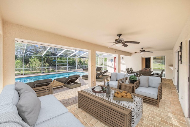 view of patio featuring an outdoor pool, an outdoor living space, a ceiling fan, and a lanai
