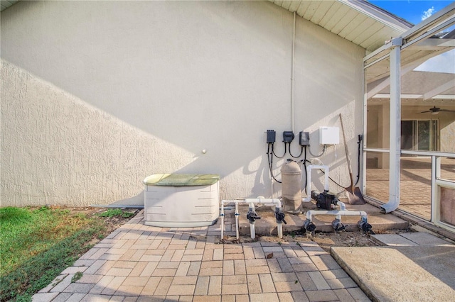 details featuring a power unit and stucco siding