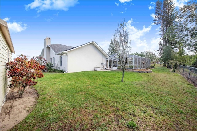 view of yard with a fenced backyard and a lanai