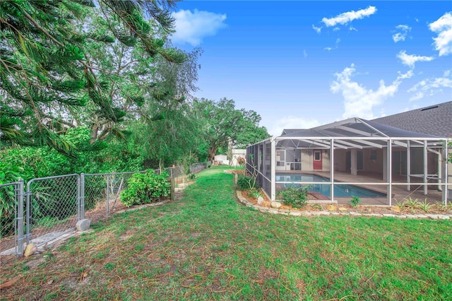 view of yard with a fenced backyard, a fenced in pool, a patio, and a lanai