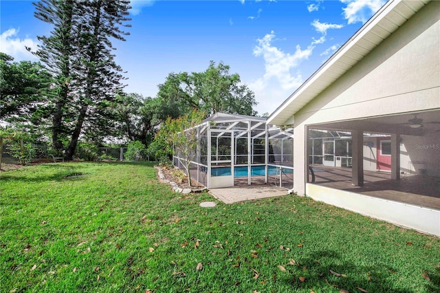 view of yard featuring a lanai, an outdoor pool, and a patio