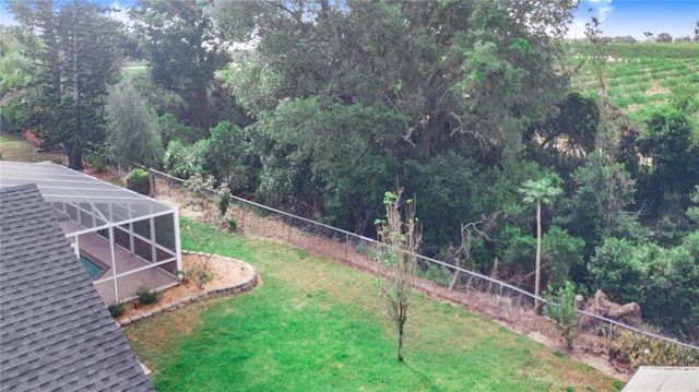 view of yard with glass enclosure