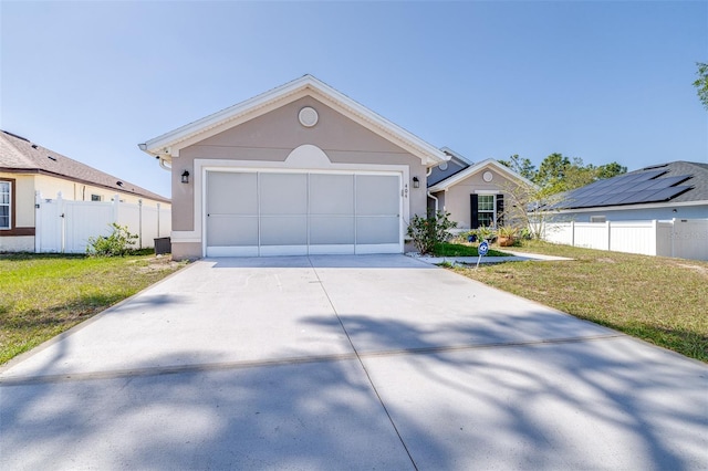 404 Rio Grande Ct, Poinciana, FL 34759 - view of front of house featuring concrete driveway, a front yard, stucco siding, and fence