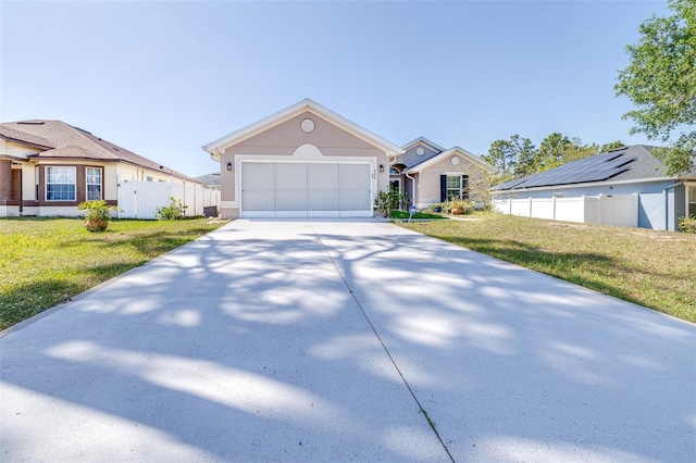 404 Rio Grande Ct, Poinciana, FL 34759 - view of front of property with concrete driveway, stucco siding, an attached garage, a front yard, and fence