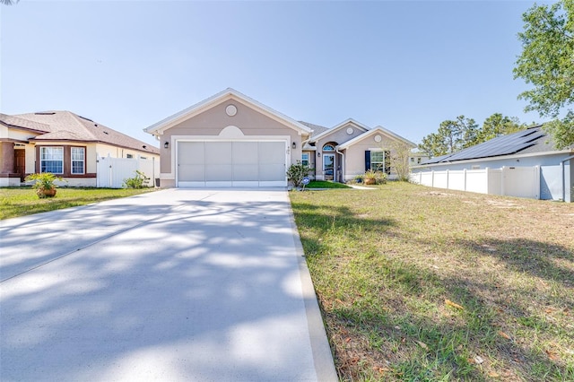 404 Rio Grande Ct, Poinciana, FL 34759 - view of front facade featuring a front yard, a garage, concrete driveway, fence, and stucco siding
