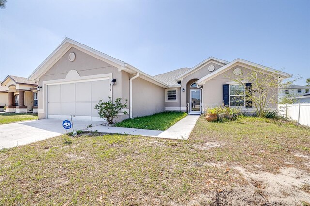 404 Rio Grande Ct, Poinciana, FL 34759 - single story home with a garage, a front yard, driveway, and stucco siding