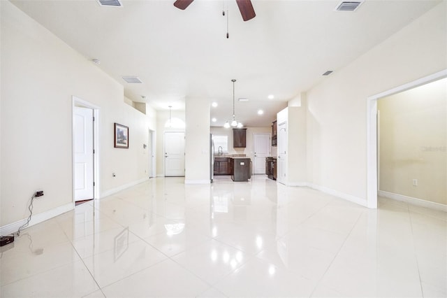 404 Rio Grande Ct, Poinciana, FL 34759 - unfurnished living room with light tile patterned floors, visible vents, baseboards, and ceiling fan