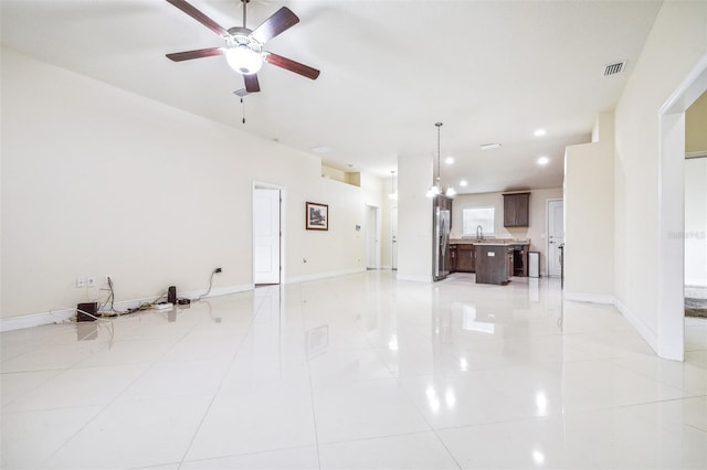 404 Rio Grande Ct, Poinciana, FL 34759 - unfurnished living room featuring a sink, light tile patterned flooring, ceiling fan, and baseboards