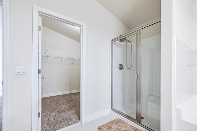 404 Rio Grande Ct, Poinciana, FL 34759 - bathroom featuring a shower stall, a spacious closet, and baseboards